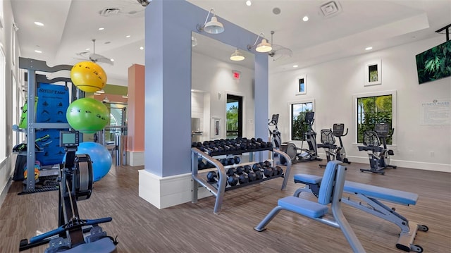 workout area featuring a towering ceiling and a wealth of natural light