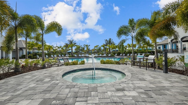 view of pool featuring a hot tub and a patio area