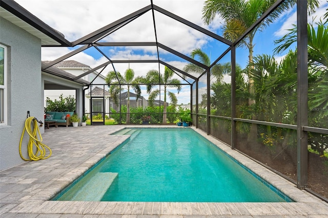 view of pool featuring outdoor lounge area, a lanai, and a patio area