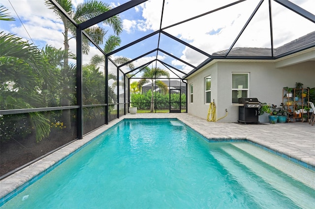 view of pool with a lanai, grilling area, and a patio area