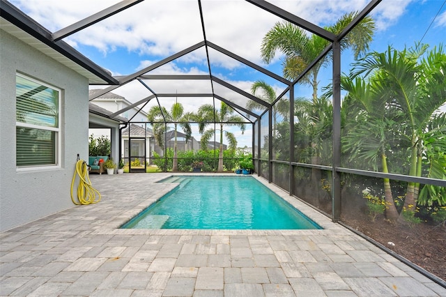 view of swimming pool with a lanai and a patio