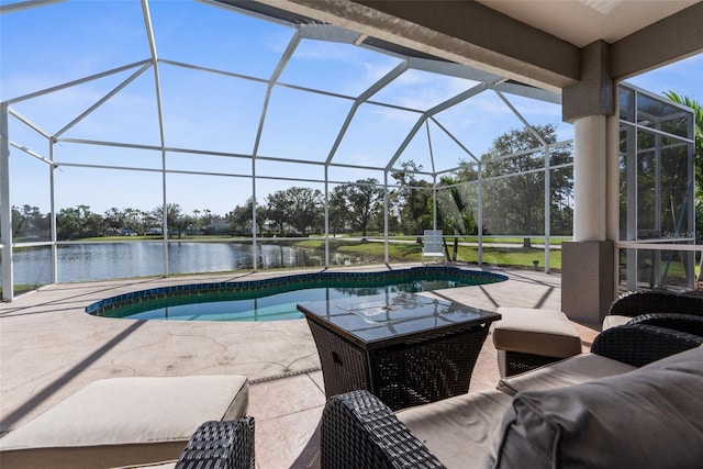 outdoor pool featuring a water view, glass enclosure, and a patio area