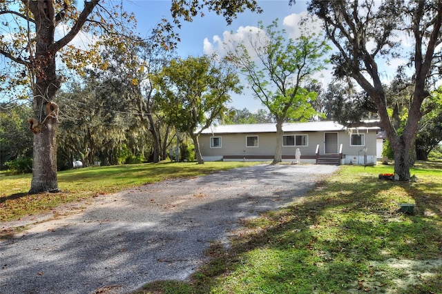 ranch-style home with a front yard