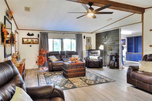 living room with vaulted ceiling with beams, ceiling fan, light wood-type flooring, and ornamental molding