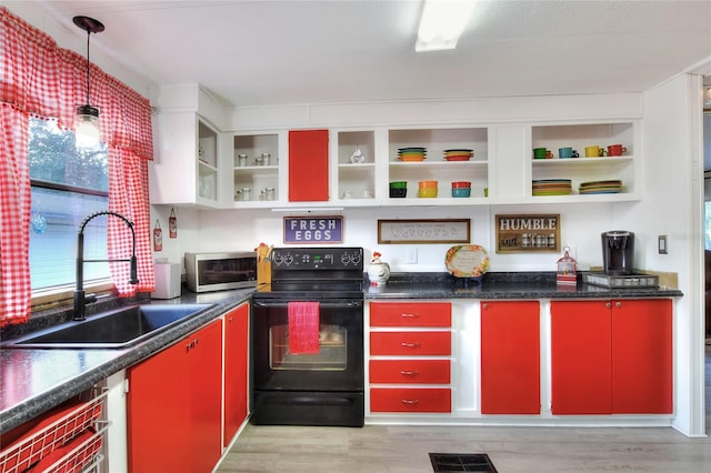kitchen featuring a wealth of natural light, light hardwood / wood-style flooring, sink, and black range with electric cooktop