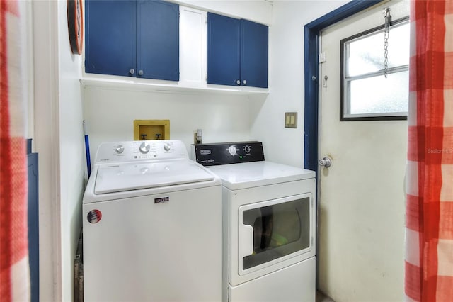 washroom featuring washer and dryer and cabinets