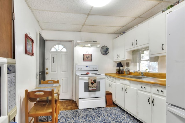 kitchen with dark parquet floors, white cabinetry, white appliances, and sink