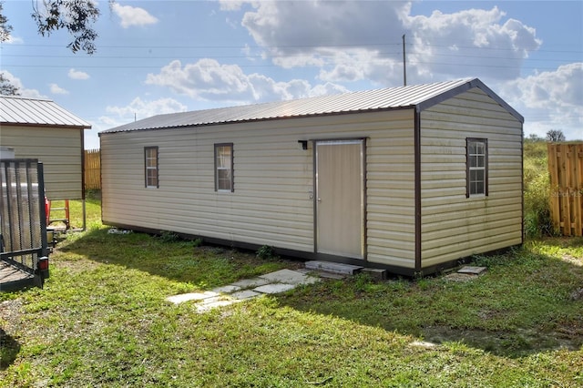 view of outbuilding with a lawn