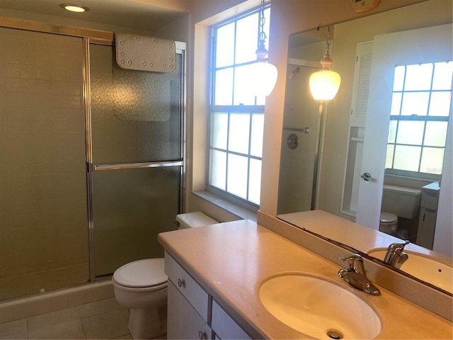 bathroom with tile patterned flooring, vanity, toilet, and a shower with door