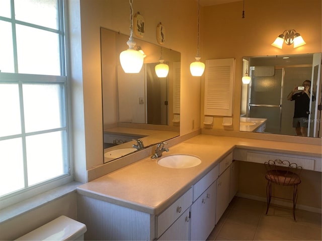 bathroom featuring an enclosed shower, plenty of natural light, vanity, and tile patterned floors