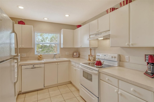 kitchen featuring white cabinetry, sink, light tile patterned floors, and white appliances