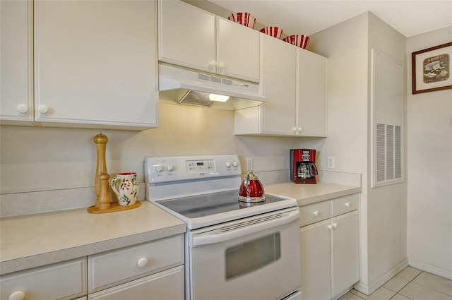 381 Bobby Jones Rd Unit 381, Sarasota, FL 34232 - kitchen with white range with electric stovetop, under cabinet range hood, light countertops, and light tile patterned flooring