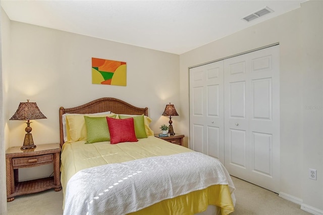 bedroom featuring light carpet and a closet