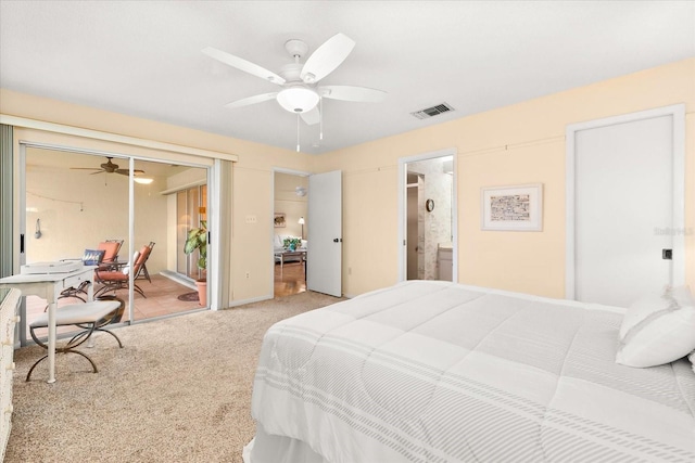 carpeted bedroom with ensuite bath and ceiling fan