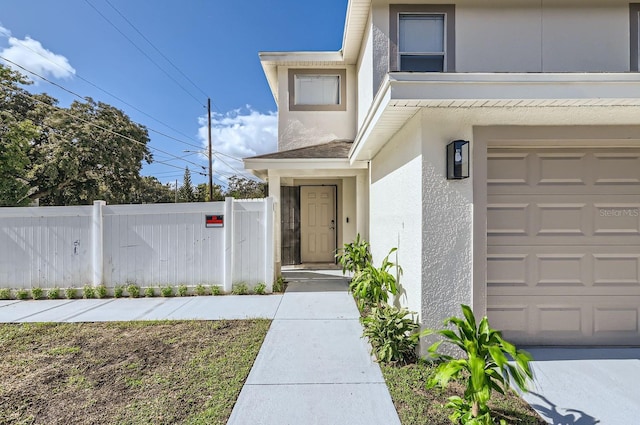 view of exterior entry featuring a garage