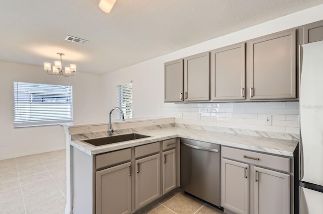 kitchen with kitchen peninsula, sink, stainless steel appliances, and plenty of natural light