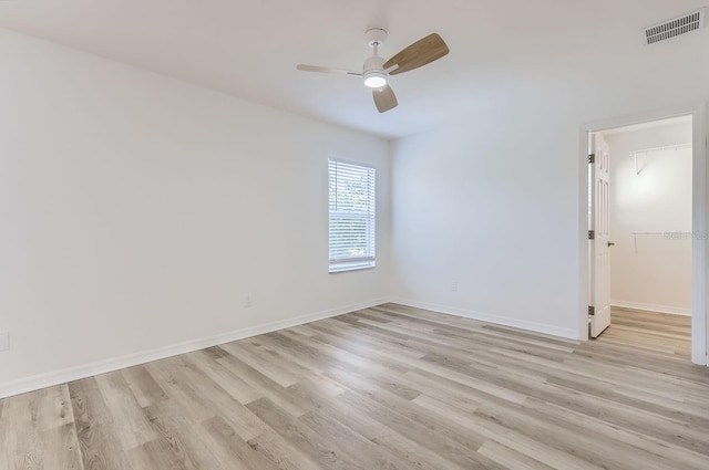 spare room featuring ceiling fan and light hardwood / wood-style floors