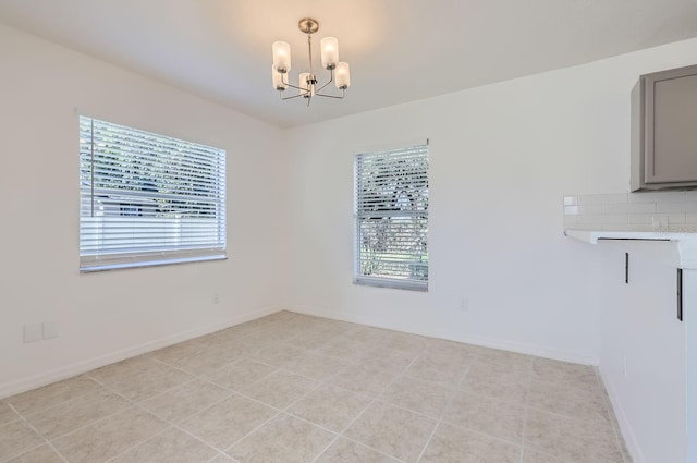 unfurnished dining area with light tile patterned flooring and a chandelier