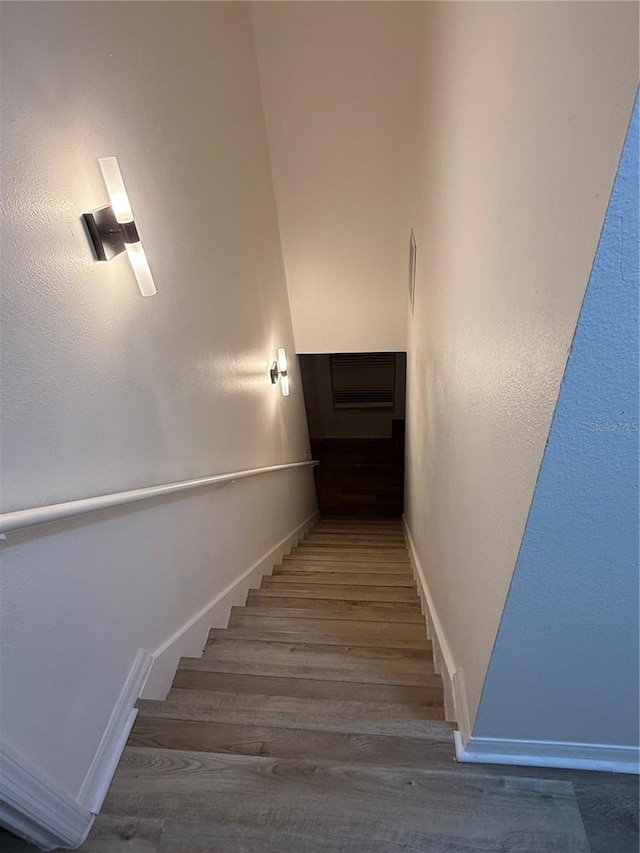 stairs featuring hardwood / wood-style floors