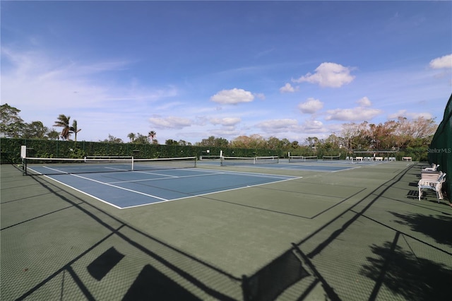 view of tennis court with basketball hoop