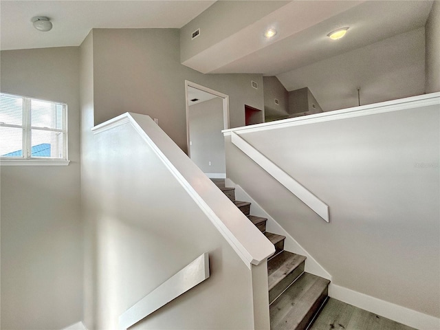 stairway featuring vaulted ceiling