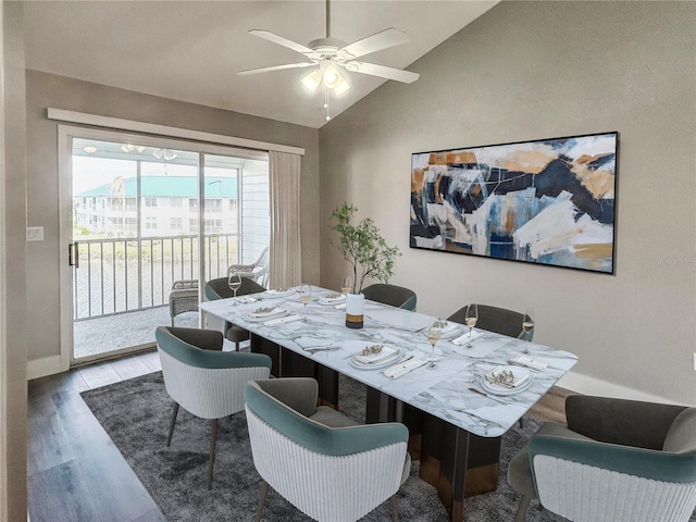 dining space with ceiling fan, light hardwood / wood-style floors, and vaulted ceiling