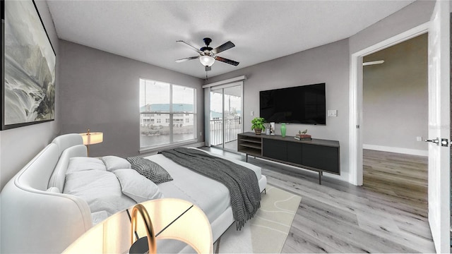 bedroom featuring access to outside, ceiling fan, and light hardwood / wood-style floors