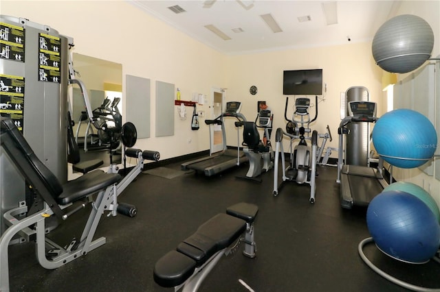 workout area featuring ornamental molding