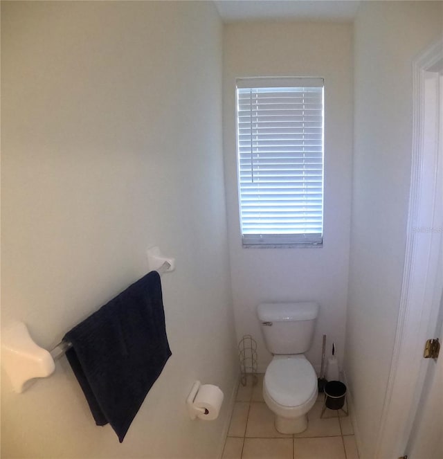 bathroom with toilet and tile patterned floors