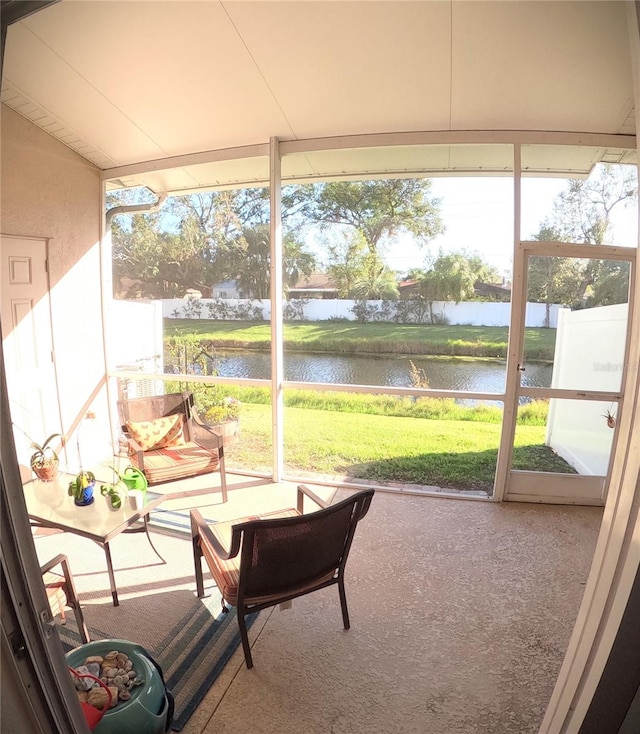 sunroom / solarium with a water view