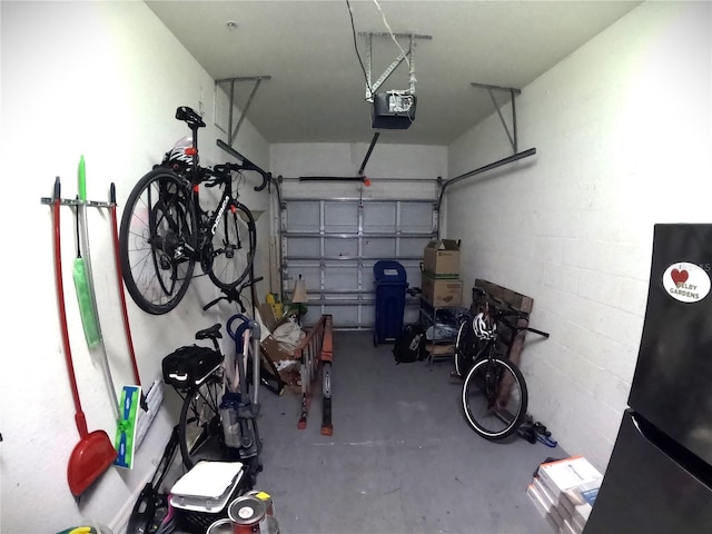 garage with refrigerator and a garage door opener