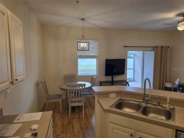 kitchen featuring decorative light fixtures, plenty of natural light, sink, and dark hardwood / wood-style flooring