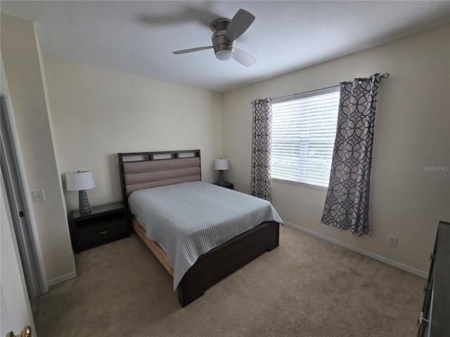 bedroom featuring ceiling fan and light carpet