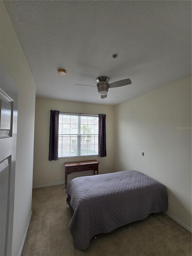 bedroom with ceiling fan and carpet flooring