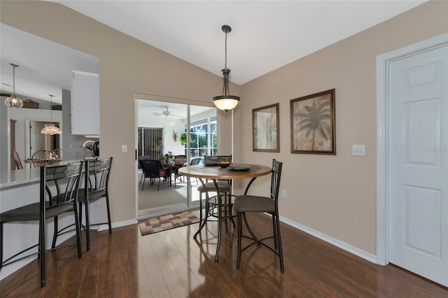 dining room featuring dark hardwood / wood-style floors, ceiling fan, and lofted ceiling