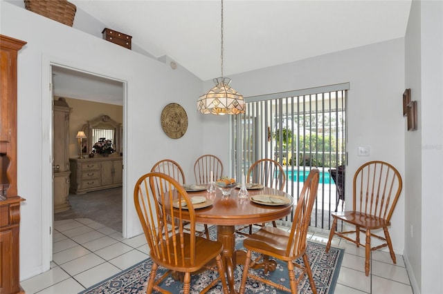 tiled dining space with vaulted ceiling