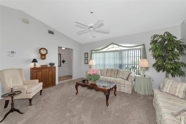 carpeted living room with ceiling fan and lofted ceiling