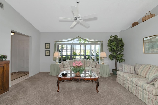 carpeted living room with ceiling fan and lofted ceiling