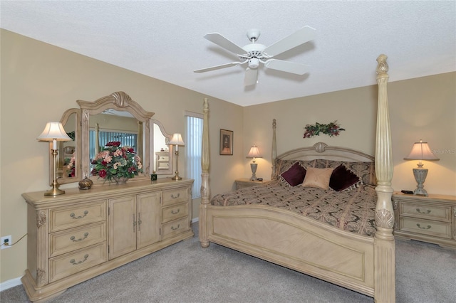 carpeted bedroom with ceiling fan and a textured ceiling