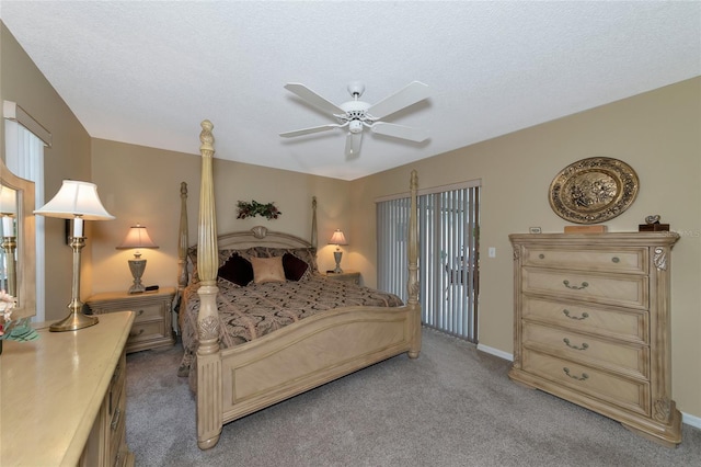 bedroom with ceiling fan, light carpet, and a textured ceiling