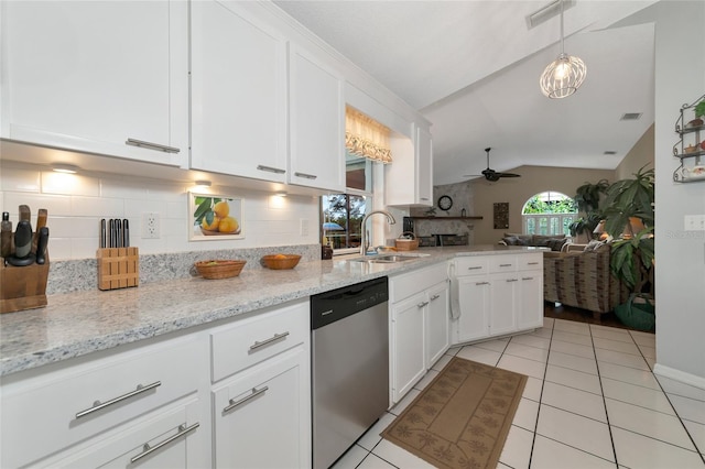 kitchen with white cabinets, dishwasher, sink, and vaulted ceiling