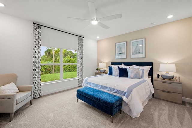 bedroom featuring light colored carpet and ceiling fan