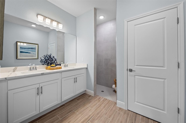 bathroom featuring vanity and a tile shower