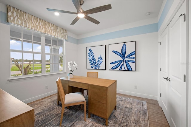 office area featuring dark wood-type flooring and ceiling fan