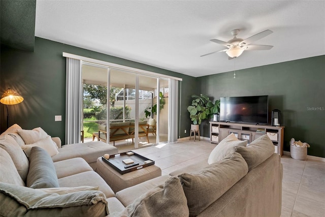 living room with a textured ceiling, light tile patterned floors, and ceiling fan