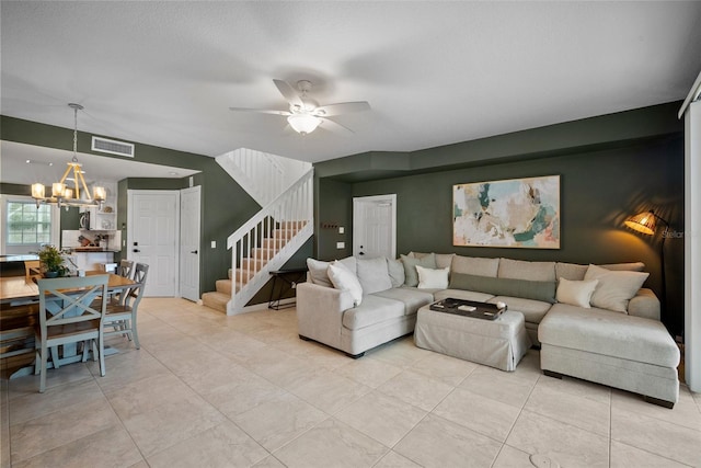 living room with ceiling fan with notable chandelier