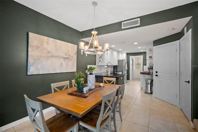 tiled dining room featuring a chandelier