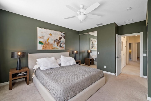 carpeted bedroom with ceiling fan and a closet