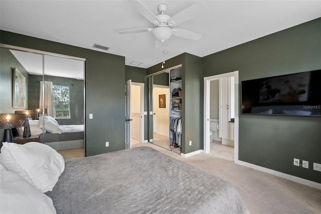 bedroom with connected bathroom, light carpet, and ceiling fan