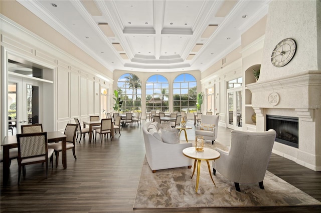 living room featuring a fireplace, dark hardwood / wood-style floors, crown molding, and coffered ceiling